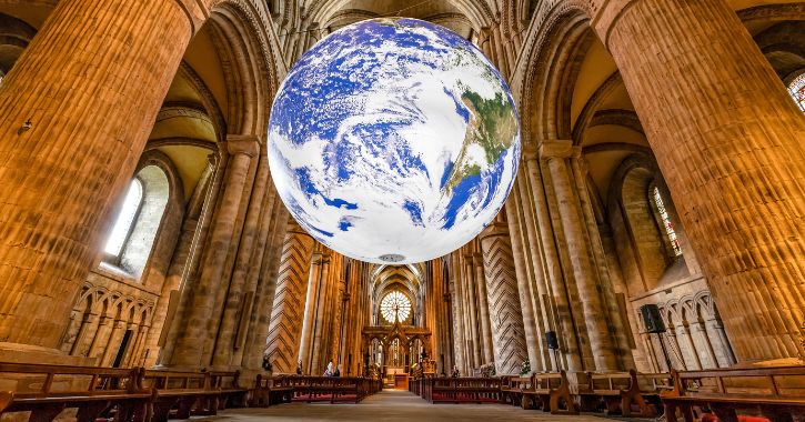 A installation of a large world hanging in Durham Cathedral