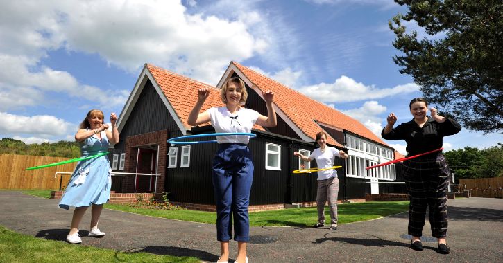 Women hula hooping in front of 1950's Welfare Hall at Beamish Museum