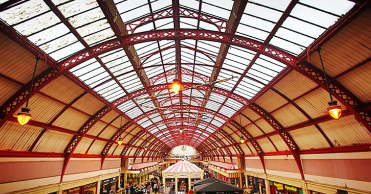 Interior of Grainger Market, red metal arches on ceiling