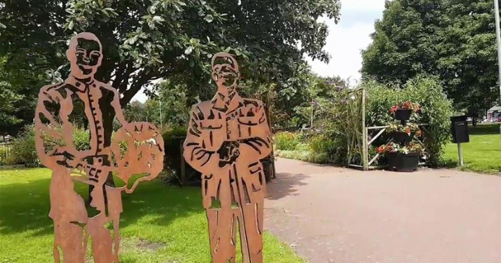 Local Heroes sculpture of cut out figures surrounded by greenery of Ridley Park