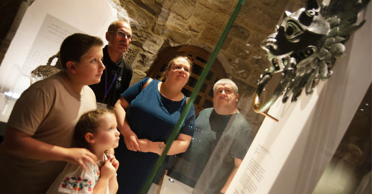 Family and Durham Cathedral staff member looking at the Sanctuary Ring