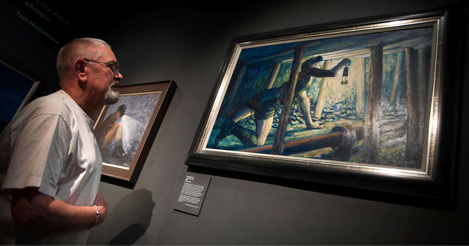 man admiring artwork on display in the Mining Art Gallery, Bishop Auckland