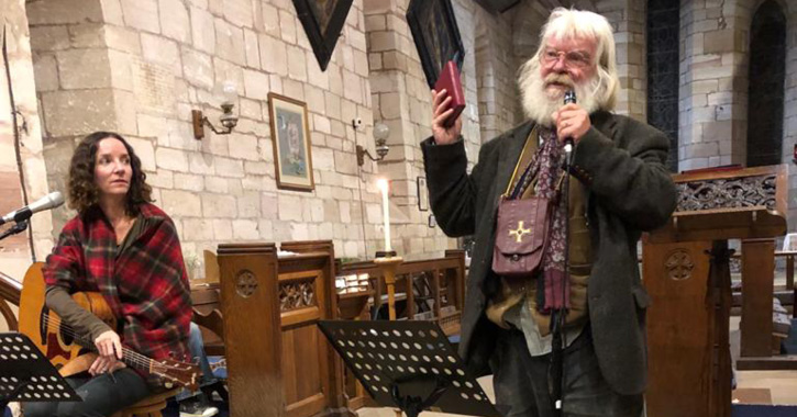 Malcolm Guite reads his Cuthbert poems as singer Alana Levandoski looks on.