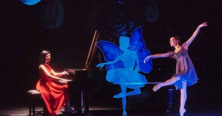 The Nutcracker and I performance, ballerina dancing with a hologram and woman in red dress playing piano 