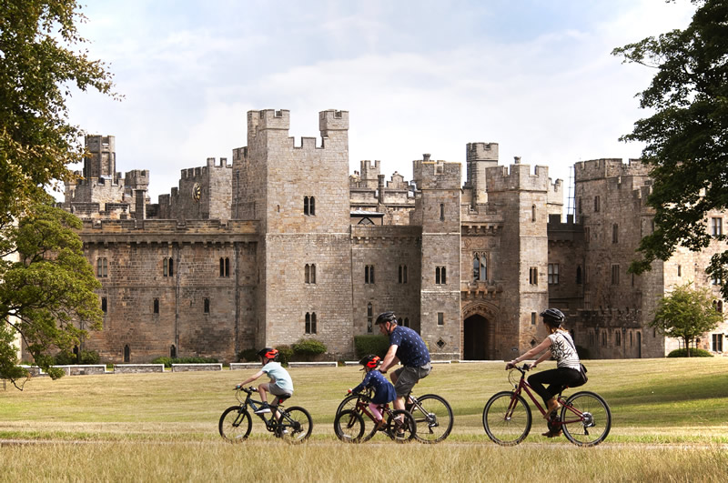 Family cycling outside of Raby Castle
