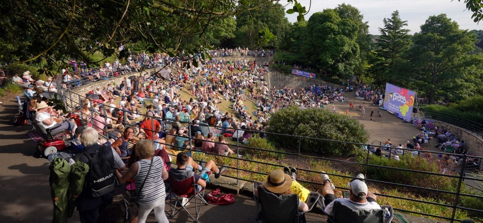 A crowd watching a performance at Wharton Park