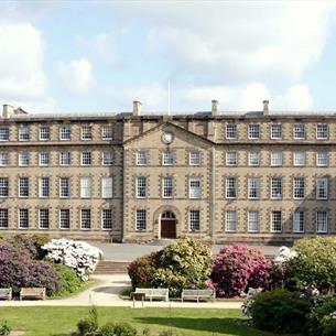 Exterior view of the front of Ushaw with Northern Saints Trails logo
