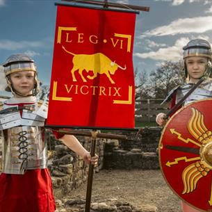 Two children dressed as Roman soldiers in their armour at Binchester Roman Fort. 