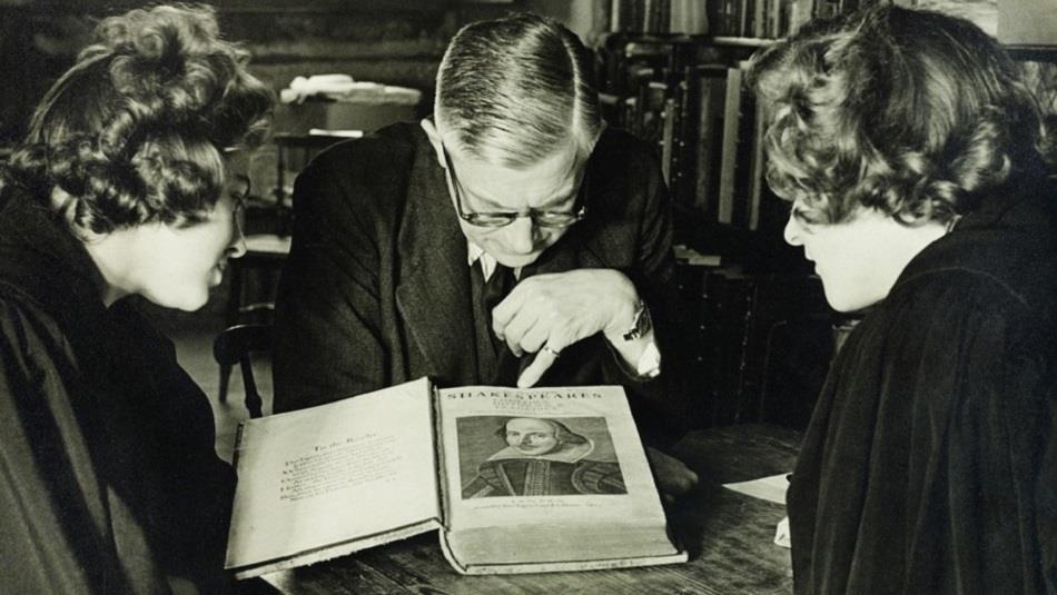 Three people looking at Shakespeare's manuscript at Palace Green Library