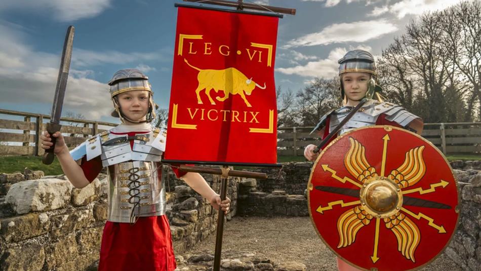Two children dressed as Roman soldiers in their armour at Binchester Roman Fort.