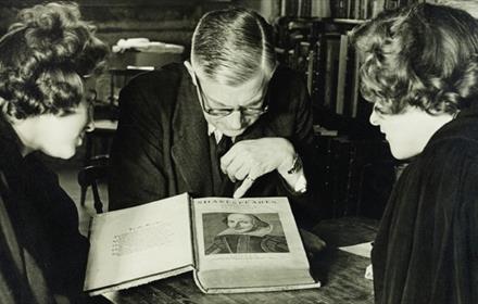 Three people looking at Shakespeare's manuscript at Palace Green Library
