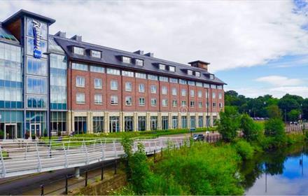 Exterior view of the Radisson Blu overlooking river.
