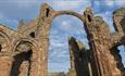 Image of Lindisfarne Priory on a sunny day - English Heritage.