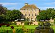 Exterior view of Headlam Hall, blue skies with gardens in foreground.