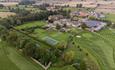 An aerial view of Headlam Hall hotel, the grounds and on site golf course. A tennis court is also visible.