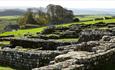 Image of Housesteads Roman Fort and rolling hills in the background. English Heritage.