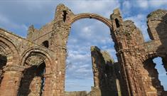 Image of Lindisfarne Priory on a sunny day - English Heritage.