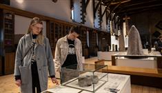 A couple looking at exhibitions inside Durham Cathedral Museum