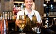 Image of a staff member serving drinks at the bar at The Seaburn Inn.