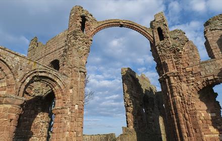 Image of Lindisfarne Priory on a sunny day - English Heritage.