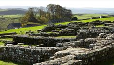 Image of Housesteads Roman Fort and rolling hills in the background. English Heritage.