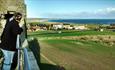 Image of a visitor enjoying sea views from Cresswell Tower.