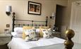 Double bed, cushions, picture, wall lights