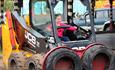 Robot diggers with children driving at Diggerland Durham